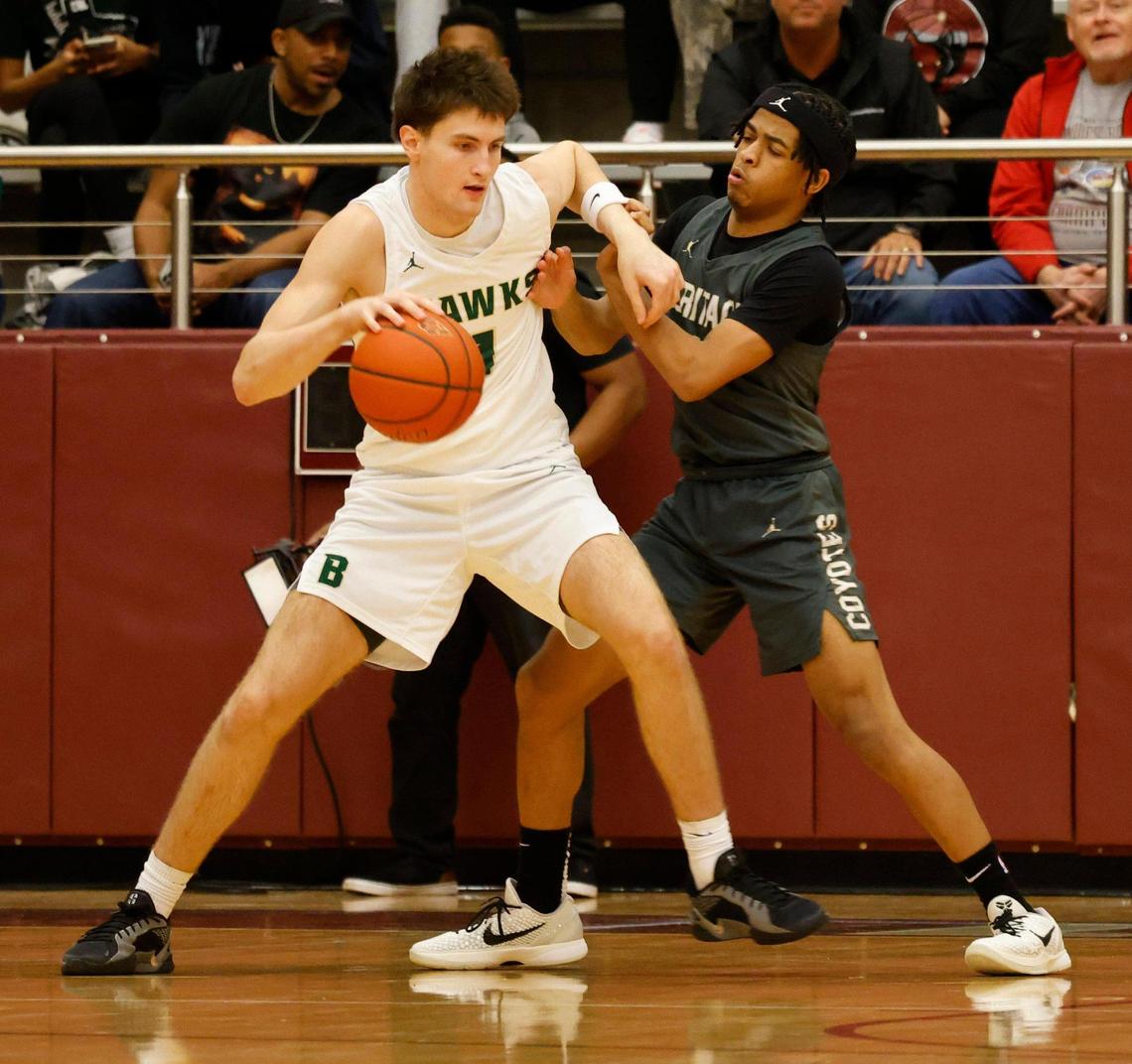Frisco Heritage point guard Garrett Shelton (1) battles Birdville forward Sawyer Dotson (1) for the ball during the first half of the UIL 5A state semifinal playoff basketball playoff game at Lewisville High School in Lewisville Texas, Tuesday, Mar. 04, 2025.