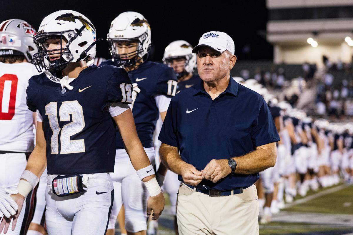 Keller Head Coach Carl Stralow walks with his team following a 31-28 loss after a non-district game between Keller and Flower Mound Marcus at Keller ISD Stadium on August 28, 2025.