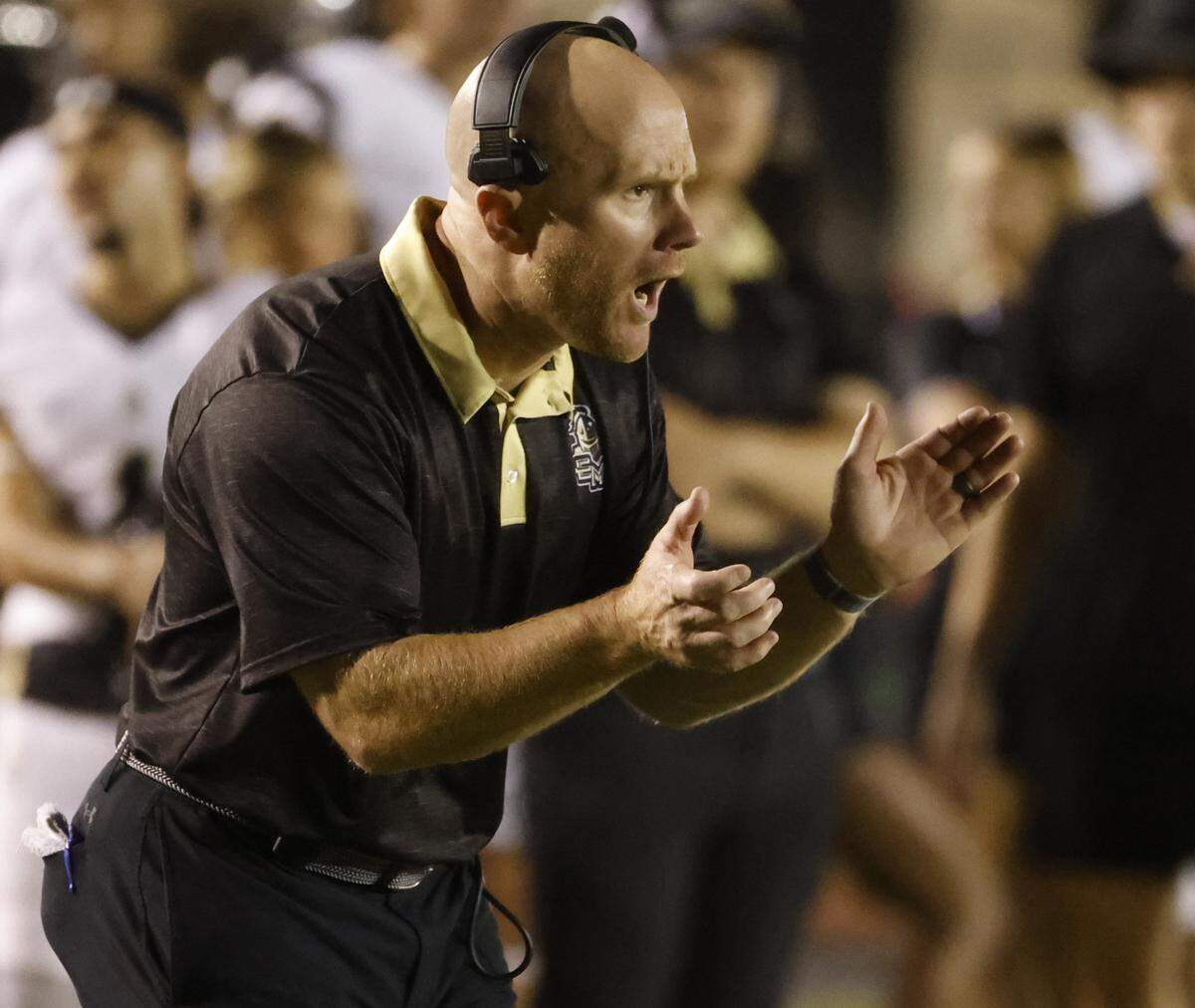 Eagle Mountain head coach Jeremy Mullins cheers on his team during the second half of a UIL football game between Eagle Mountain and Benbrook at Farrington Field in Fort Worth, Texas, Friday, Sept. 26, 2025.