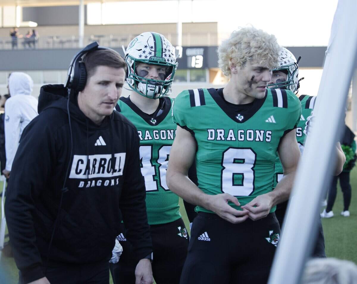Southlake defensive coordinator Lee Munn talks with players including defensive lineman Zac Hays (8) during the second half of a UIL Class 6A Division II Quarterfinal on Saturday Dec. 06, 2025 at Crowley ISD Multi-Purpose Stadium in Fort Worth, Texas.