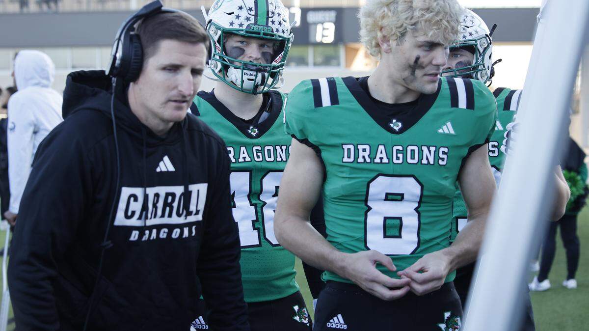 Southlake defensive coordinator Lee Munn talks with players including defensive lineman Zac Hays (8) during the second half of a UIL Class 6A Division II Quarterfinal on Saturday Dec. 06, 2025 at Crowley ISD Multi-Purpose Stadium in Fort Worth, Texas.