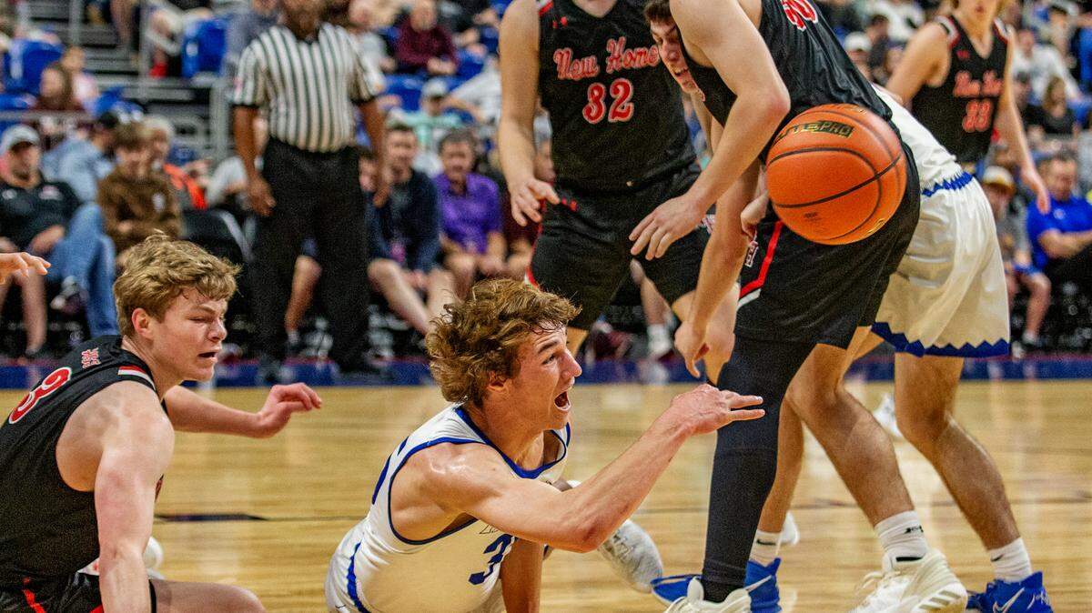 Lipan’s Reese Cook dives to keep the basketball alive against New Home in the first semifinal game of the UIL Texas Class 2A boys basketball tournament at the Alamodome in San Antonio on Friday.