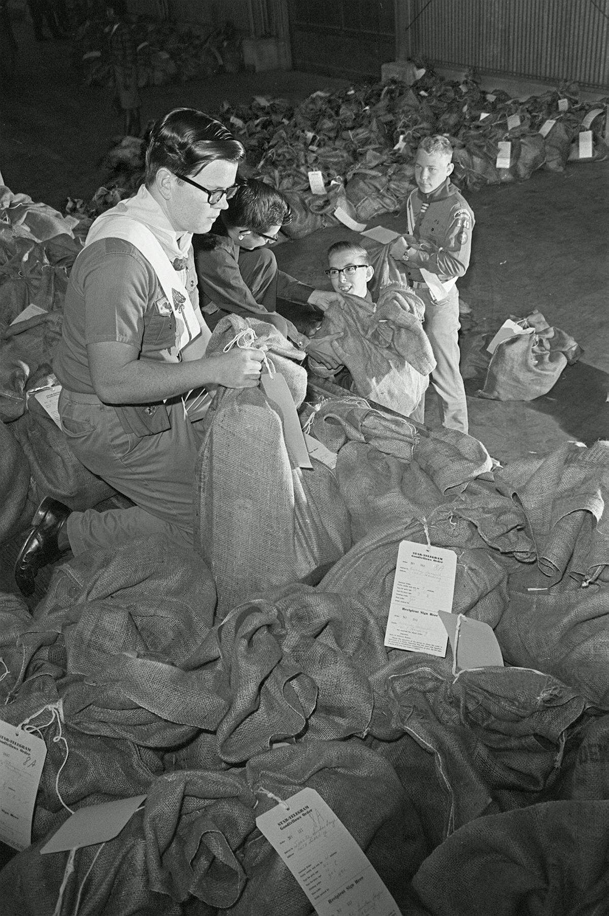 Dec. 24, 1965: Boy Scouts turned Santa’s helpers in readying a sea of sacks that Goodfellows filled for needy children. Among the helpers were Scouts Billy Carver, Explorer Larry Hyink, Explorer Billy Wilson and Scout Tommy Teter, left to right.