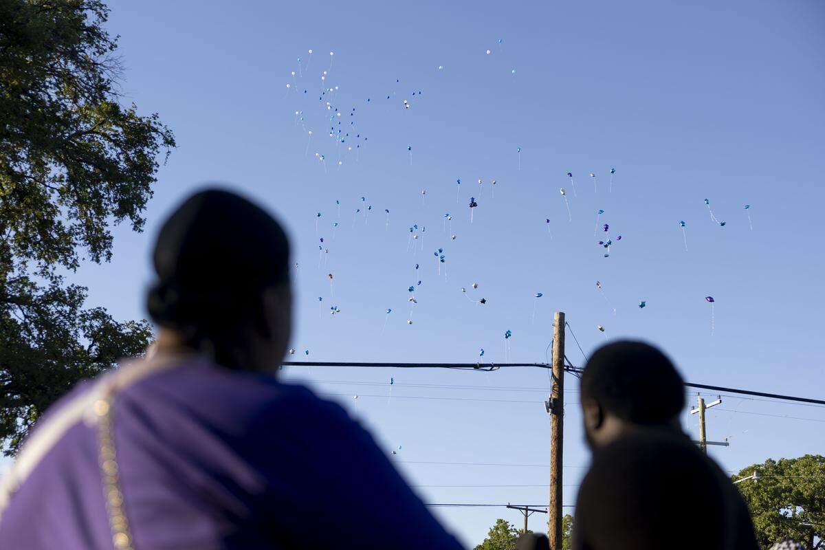 Family of Dominique Coleman watch balloons rise to the sky in his honor on Tuesday, May 12, 2026 in Fort Worth, Texas. Coleman, who was working as a security guard at Club New Start on Miller Avenue, was shot and killed early Sunday during an argument with customers outside the club.