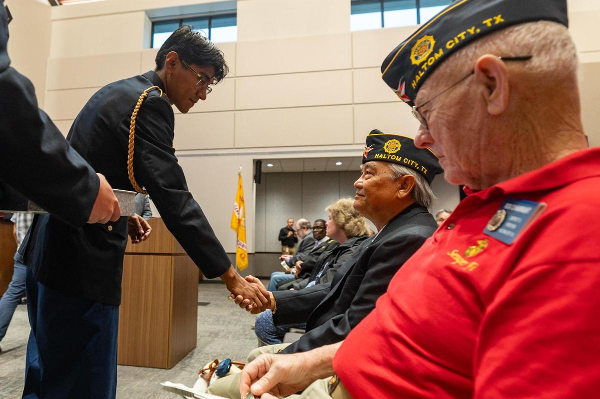 Cesar Hernandez, left, of the Haltom City High School ROTC hands out commemorative pins to Vietnam War veterans in attendance of the 50th Anniversary of the Vietnam War event at Haltom City City Hall in Fort Worth on Wednesday, April 30, 2025.