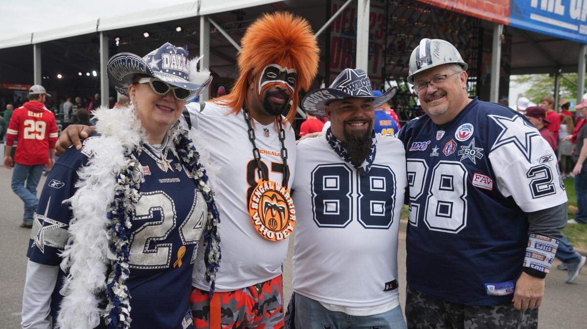 Dallas Cowboys and Cincinnati Bengals fans pose for a photo before the first round of the 2023 NFL Draft at Union Station.