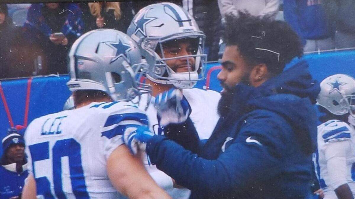 Dallas Cowboys running back Ezekiel Elliott (right) was held out of the season finale against the New York Giants to keep him safe for the playoffs, per owner Jerry Jones.
