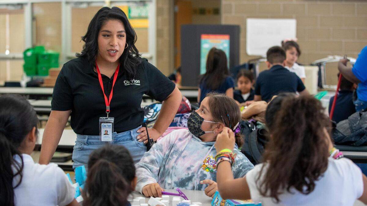 Activity leader Cristina Garcia talks to students in a classroom.