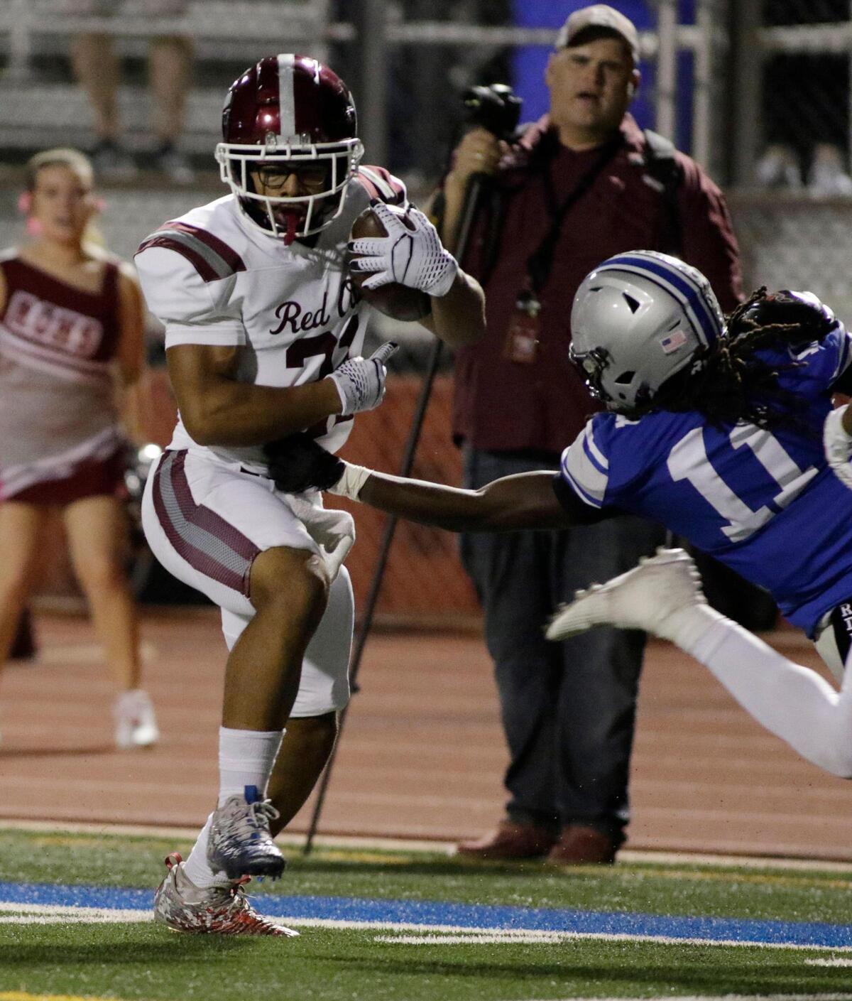 Red Oak’s Lorenzo Holman dodges a tackle by Burleson’s Brenton Hardin during a UIL football game at Burleson ISD Stadium on Friday October 25, 2024.
