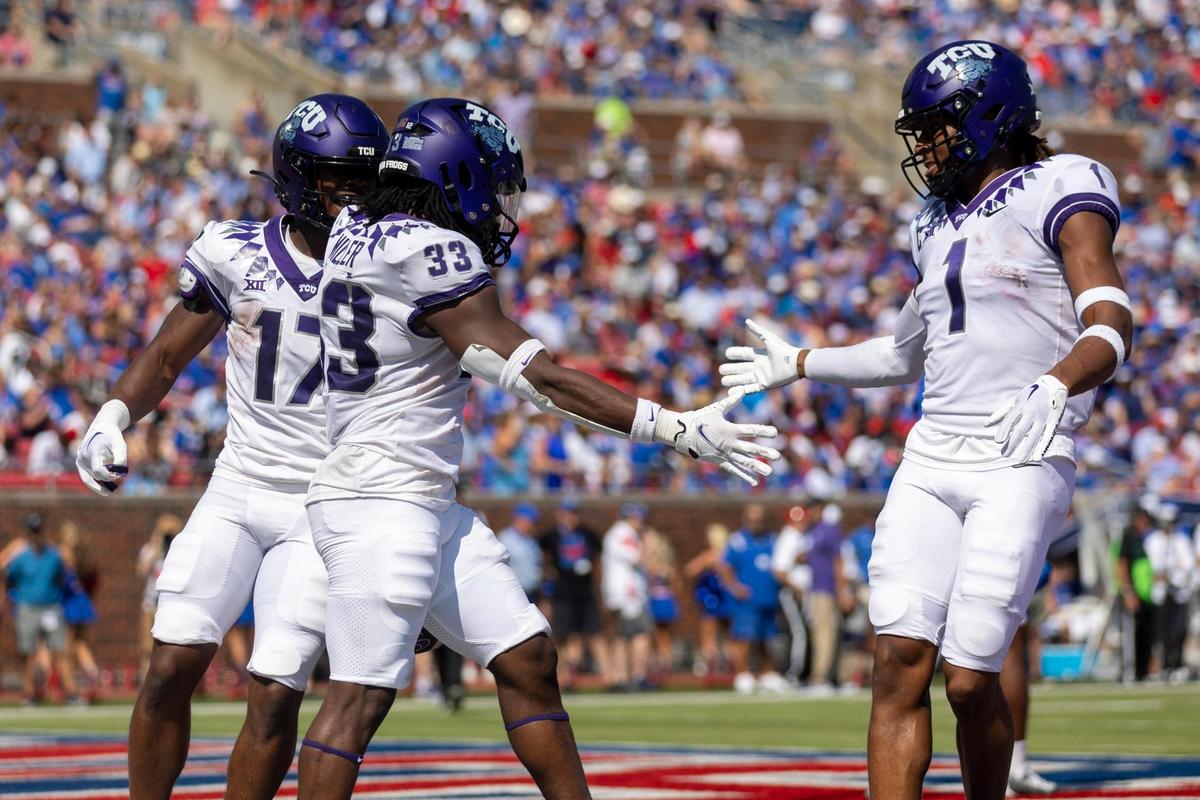 TCU running back Kendre Miller high fives wide receiver Quentin Johnston after scoring a touchdown on Saturday, Sept. 24, 2022, at the Gerald Ford Stadium in the Southern Methodist University in Dallas, Texas.