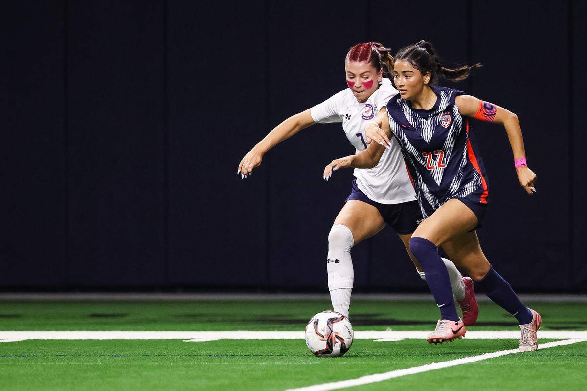 Grapevine forward Hope Harvill (7) attempts to steal the ball from a Frisco Wakeland player in a Class 5A Division II UIL girls soccer state semifinal at the Ford Center on April 3, 2026 in Frisco, Texas.