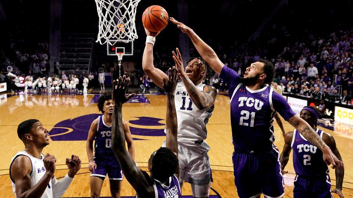 Kansas State forward Keyontae Johnson (11) shoots under pressure from TCU forward JaKobe Coles (21) during the second half of an NCAA college basketball game Tuesday in Manhattan, Kan.