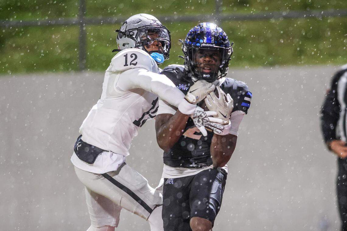 Byron Nelson’s Mahamadou Siby hauls in a touchdown pass in front of Denton Guyer’s AJ Moss (12) in a Class 6A Division II regional semifinal Friday at Northwest ISD Stadium in Justin.
