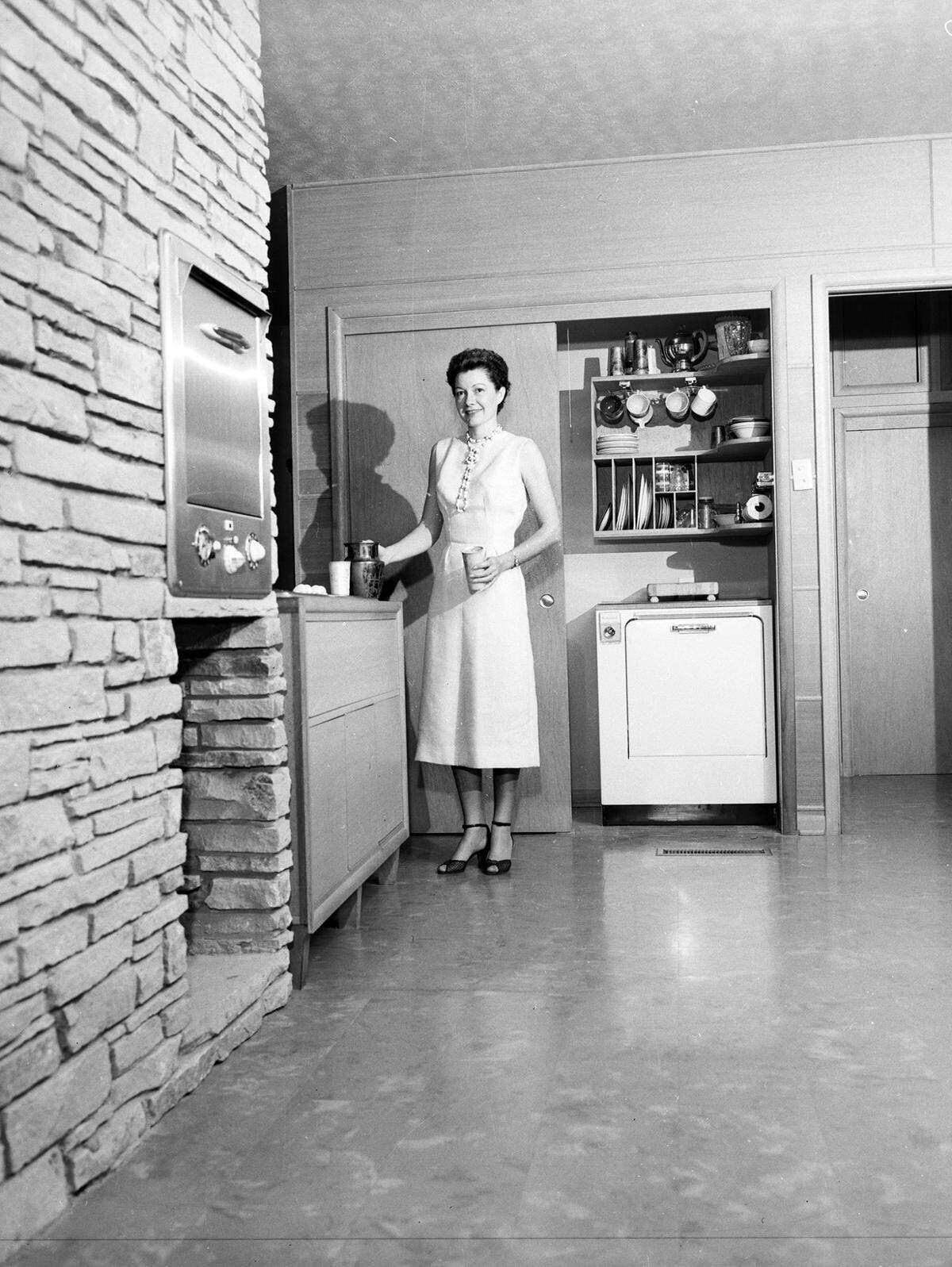 April 5, 1955: Mrs. Stanley standing in the kitchen in the family residence, Fort Worth