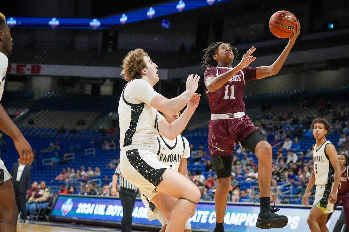 Silsbee’s Payton Jones goes up for two over Amarillo Randall’s Dawson Heider in a Class 4A state semifinal on Friday, March 8, 2024 at the Alamodome in San Antonio, Texas. Silsbee defeated Randall 75-68.