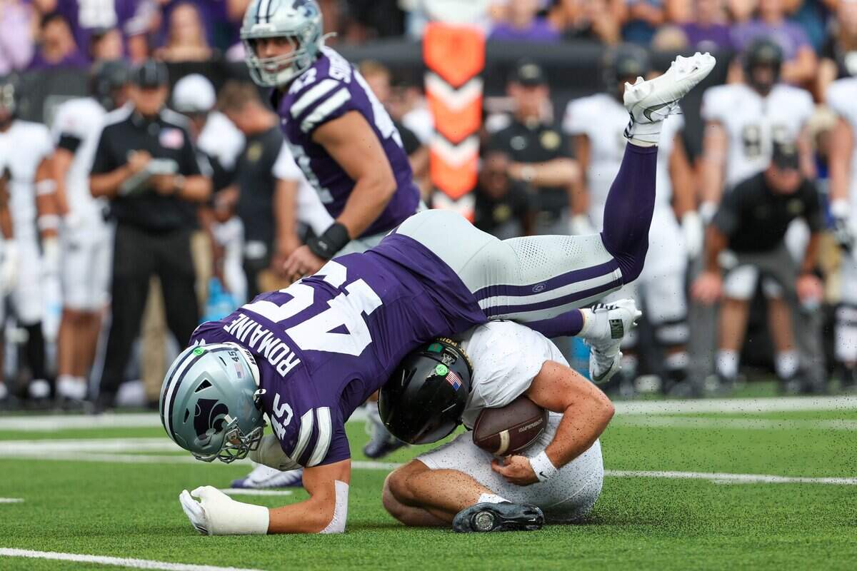 Sep 6, 2025; Manhattan, Kansas, USA; Army Black Knights quarterback Cale Hellums (3) is tackled for a loss by Kansas State Wildcats linebacker Austin Romaine (45) during the first quarter at Bill Snyder Family Football Stadium. Mandatory Credit: Scott Sewell-Imagn Images