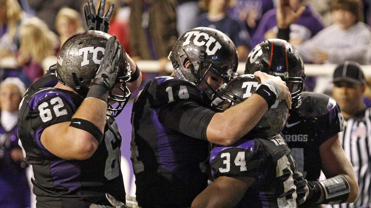 TCU’s Ed Wesley (34) celebrates scoring a touchdown with Jeff Olson (62) and Andy Dalton (14) during the TCU vs Air Force NCAA football game at Amon Carter Stadium in Fort Worth, Texas, Saturday October 23, 2010.  TCU won 38-7.