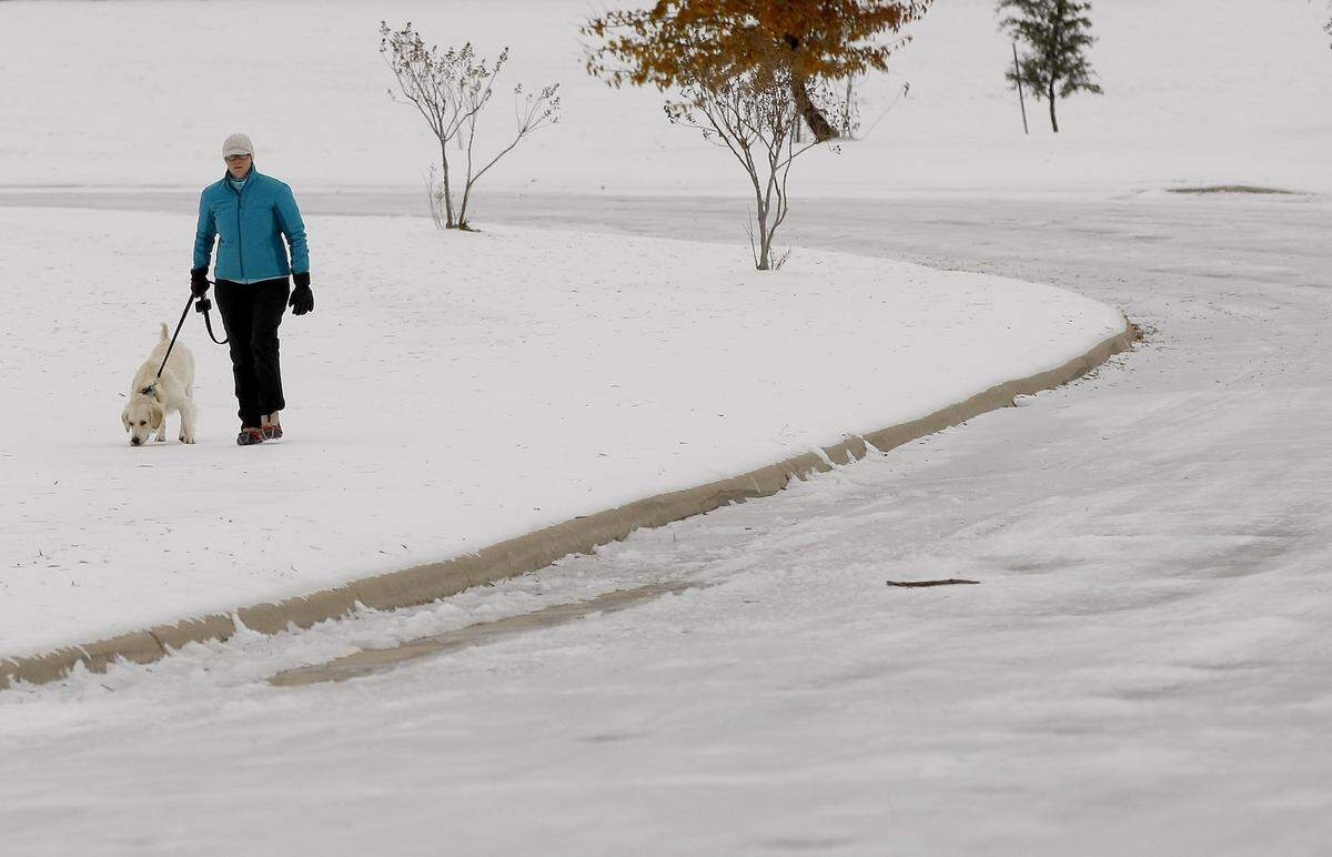Monica Foley walks her dog Clover at Eagle Ranch neighborhood in north Fort Worth on Saturday, Dec. 7, 2013.