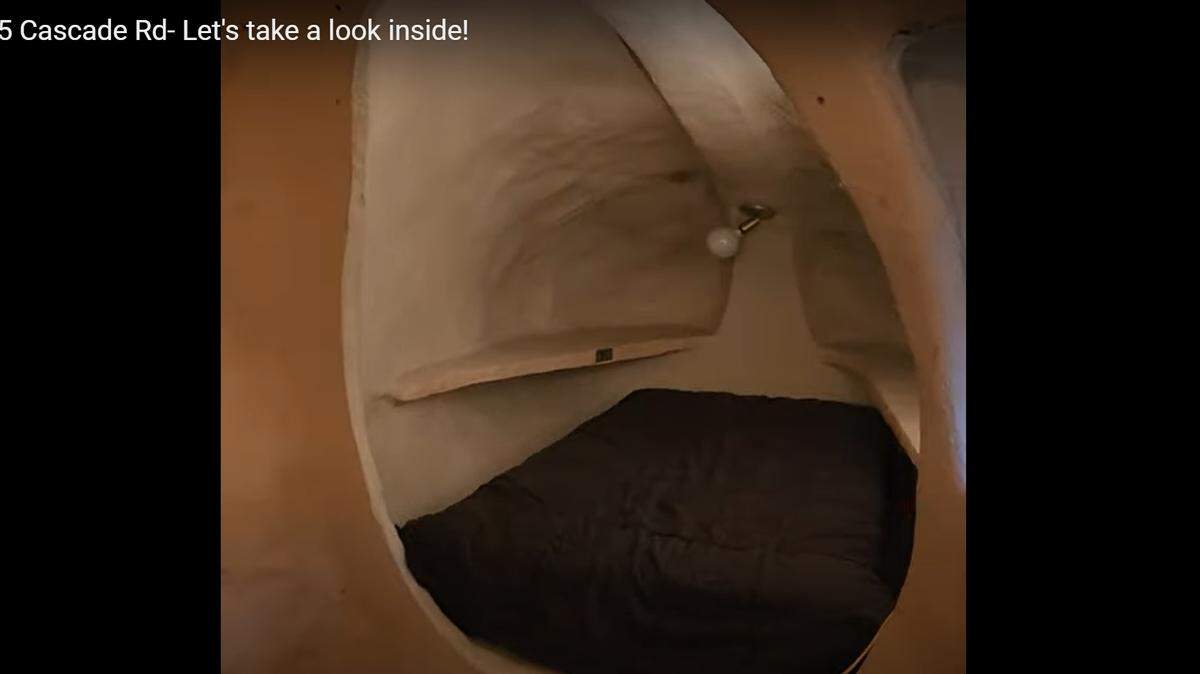 A bed nook inside the unique home.