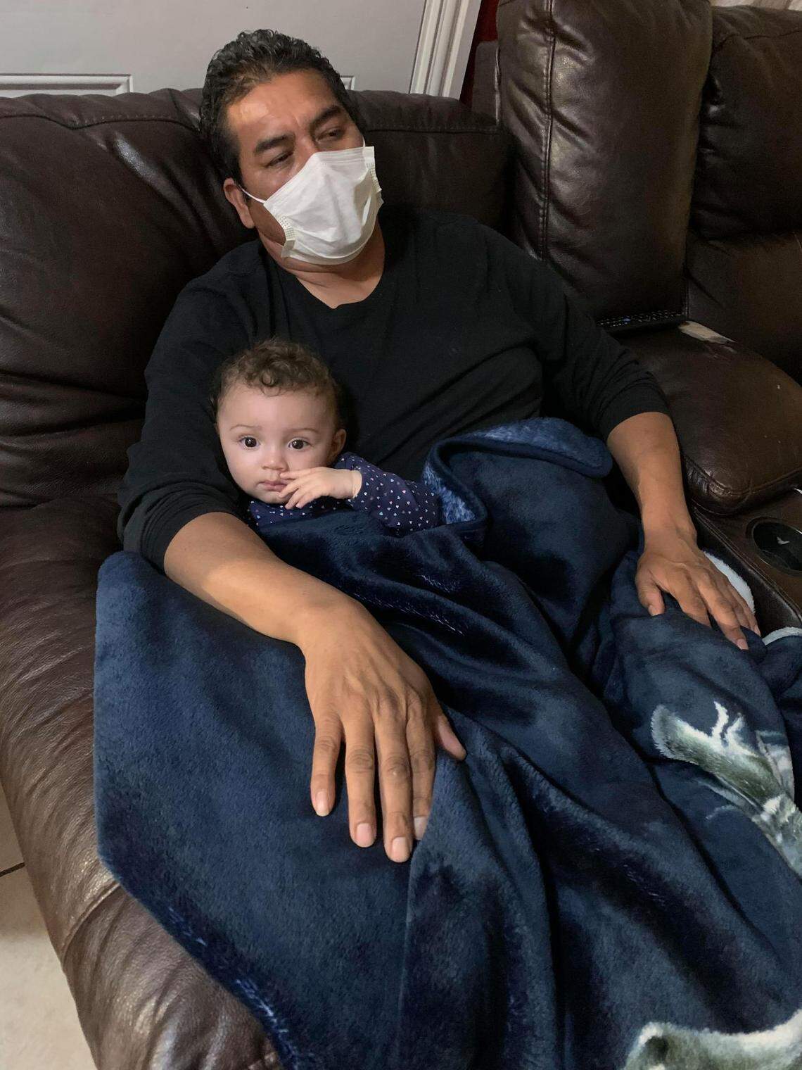 Francisco “Panchito” Macias (right), wearing a face mask, enjoys some time with his granddaughter, Kelylah Ashley. His daughters are demanding justice after he was shot and killed outside of their east Fort Worth home early on the morning of Oct. 22 as he was about to get into his pickup truck to leave for work.
