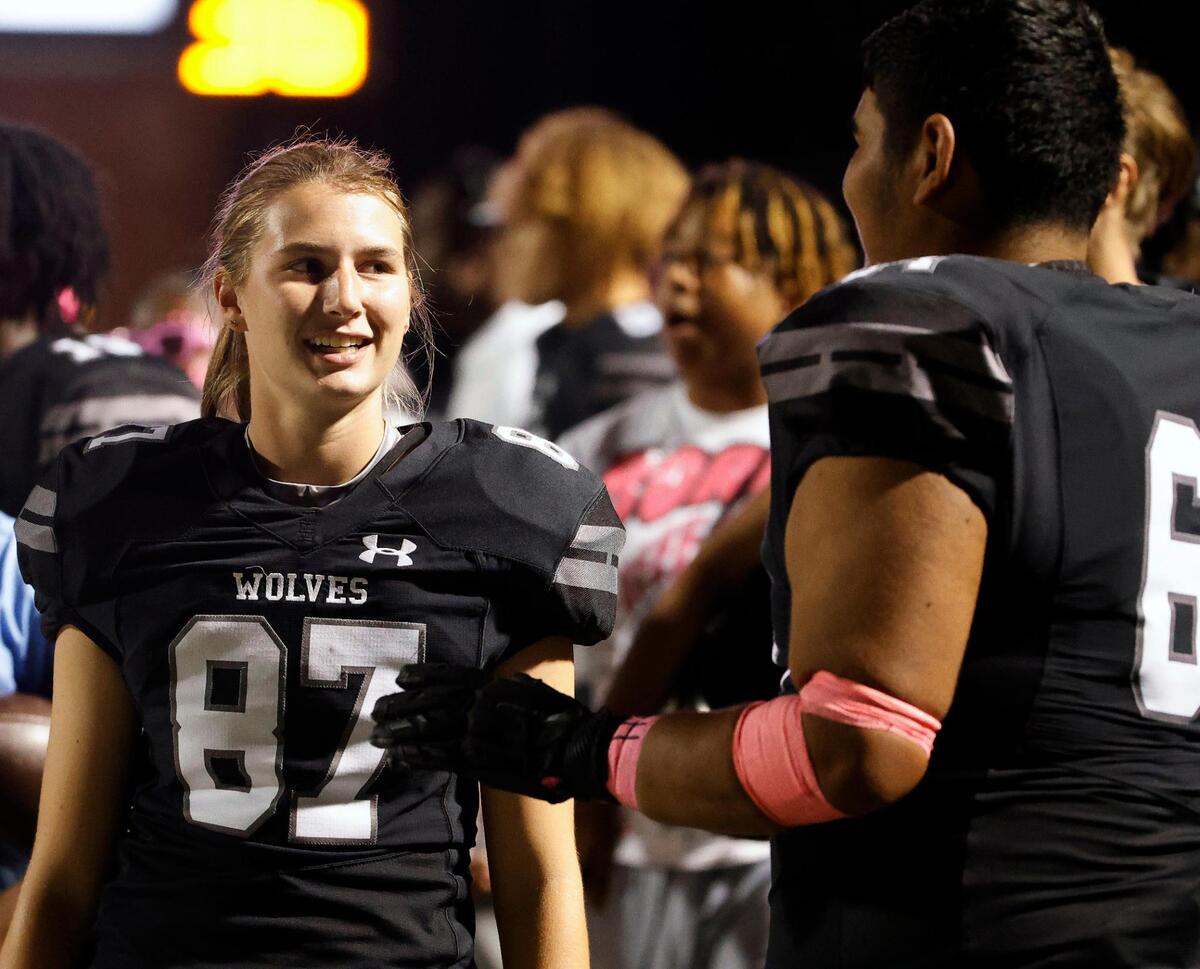 Timberview kicker Emma Young (87) talks with team mate offensive lineman Marco Herrera (64) in the second half of a UIL football game at Vernon Newsom Stadium in Mansfield, Texas, Thursday, Oct. 19, 2023.