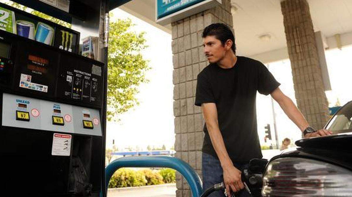 Raul Bucio, of Merced, fills up at a Valero station in Merced Tuesday. (4-8-14)