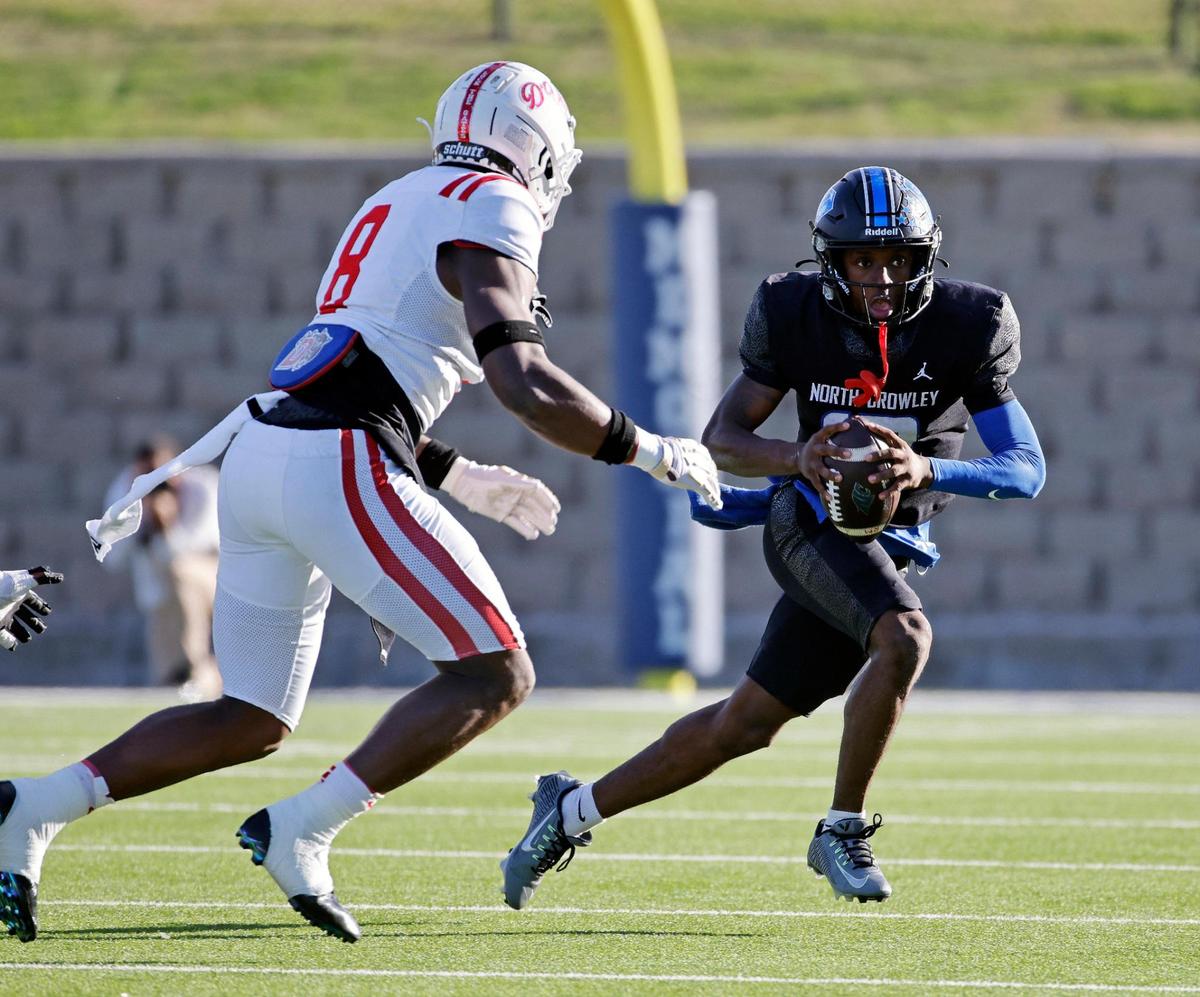 Duncanville defensive end Colin Simmons (8) pursues North Crowley quarterback Chris Jimerson (12) in the backfield during the first half of a UIL Conference 6A Division I state semifinal football playoff game at Mesquite Memorial Stadium in Mesquite, Texas, Saturday, Dec. 09, 2023. Duncanville led North Crowley 24-0 at the half.