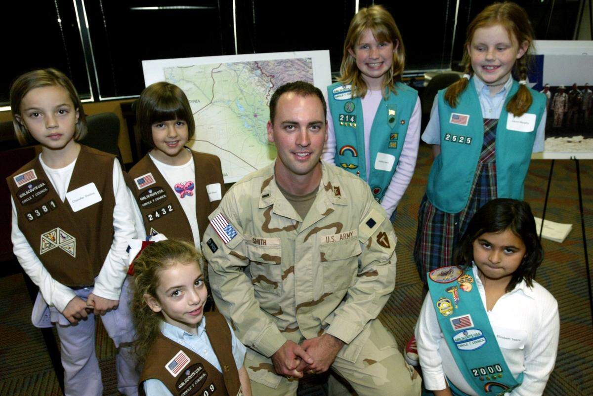 Jan. 13, 2006: Texas Army National Guard Reservist Tarlton Wade “Trooper” Smith, a civil engineer recently returned to civilian life a year’s service in Iraq, at the engineer firm Freese and Nichols with Girl Scouts after he explained how much it meant to soldiers in Iraq to receive packages from home. Scouts participated in Project Troop to Troop, selling cookies for donation to members of the armed forces. From left, back, Chandler Shabay, Elizabeth Sloan, Andrea Ayers, Laura Murphy. From left front, Zoe Roberts, Elizabeth Saenz.