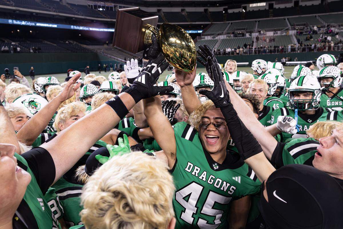 The Southlake Carroll football team celebrates after winning the UIL Division II Regional playoff game 49-31 against Prosper at Choctaw Stadium in Arlington on Friday, Nov. 28, 2025.
