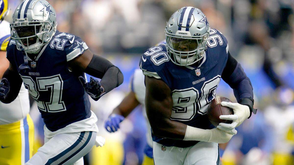 Dallas Cowboys safety Jayron Kearse (27) helps defend as defensive end DeMarcus Lawrence (90) returns a Los Angeles Rams’ Matthew Stafford fumble for a touchdown in the first half of an NFL football game, Sunday, Oct. 9, 2022, in Inglewood, Calif. (AP Photo/Ashley Landis)