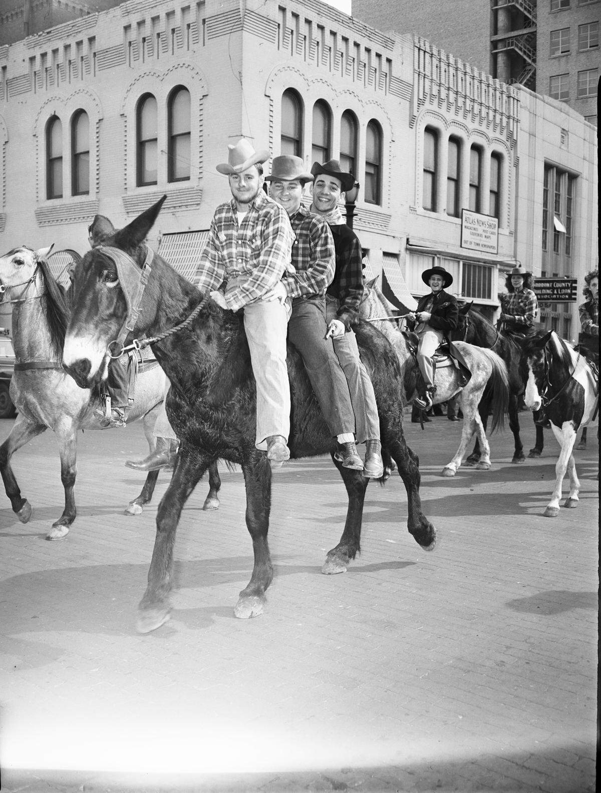 Feb. 7, 1946: Bubba Schmid, left, Lee Gallagher and Harry Mullins ride in the TCU Ranch Week parade in downtown Fort Worth.