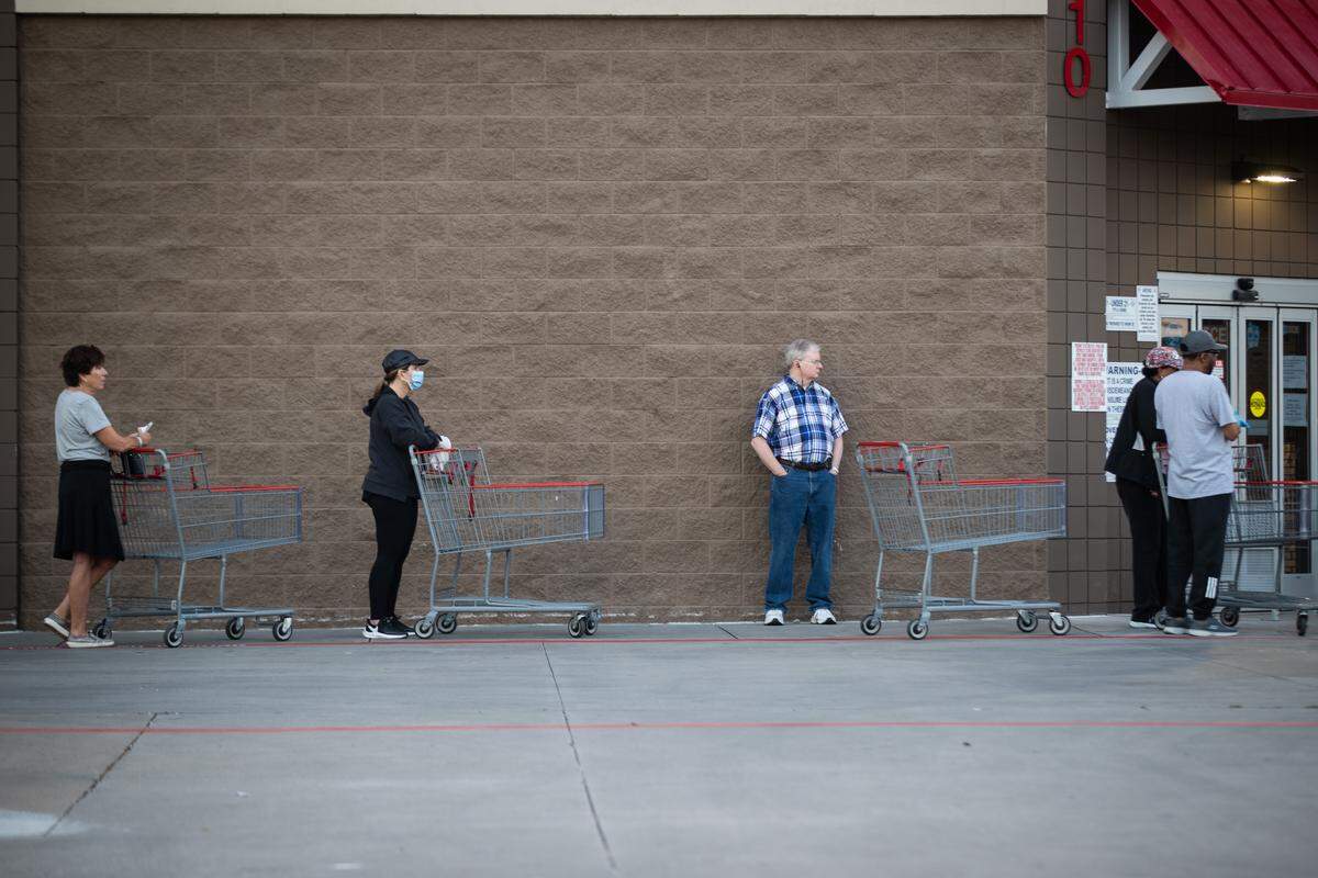 Shoppers stand 6 ft apart as they wait to shop in Costco amid the coronavirus outbreak Thursday, March 26, 2020, in Fort Worth.