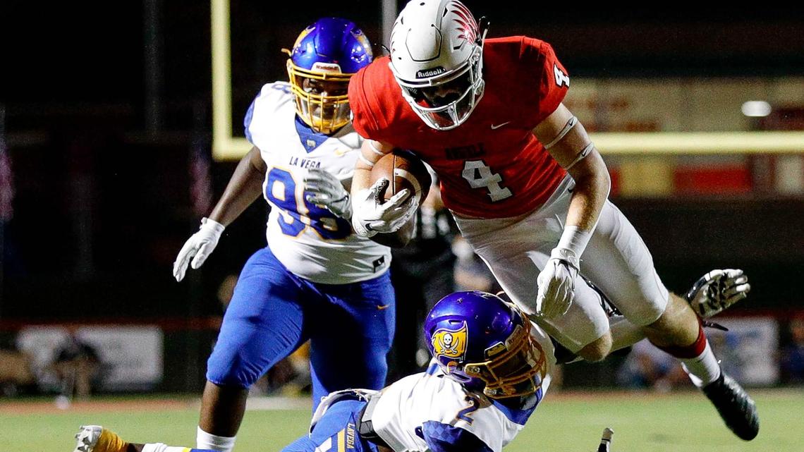 Argyle running back Knox Scoggins (4) is tripped up by Waco La Vega defensive back Marcus Willis (2) during the second half, Friday night, September 18, 2020 played at Argyle High School in Argyle, Tx. (Steve Nurenberg Special to the Star-Telegram)