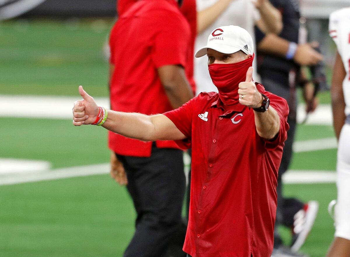 Carthage head coach Scott Surratt gives a thumbs up to the Gilmer sidelines after a Conference 4A Division 2 State Championship football game at AT&T Stadium in Arlington, Texas, Friday, Dec. 18, 2020. Carthage won their eighth state championship in 14 years defeating Gilmer 70-14. (Special to the Star-Telegram Bob Booth)