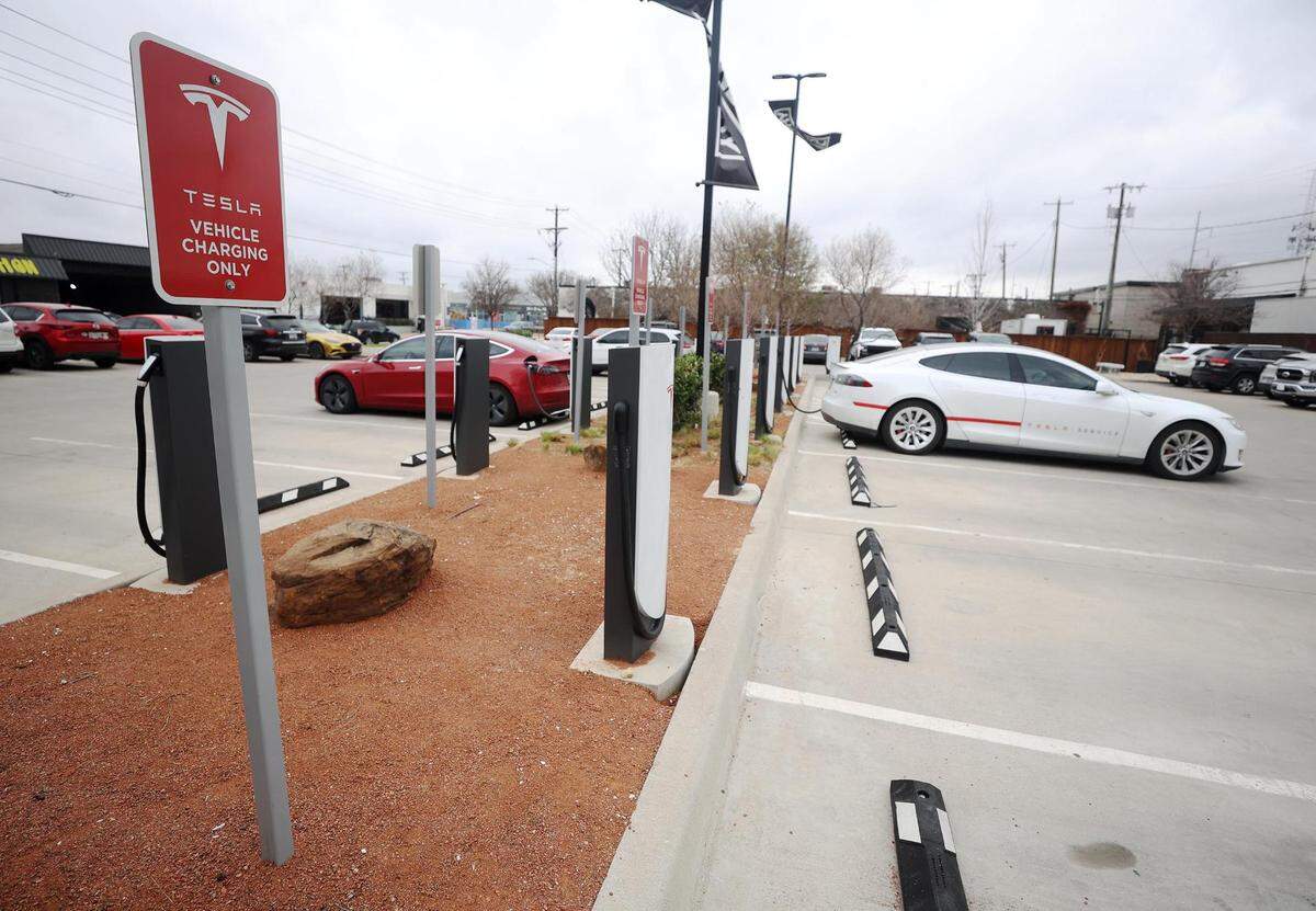Tesla vehicles charge at a Tesla Supercharger station in the Foundry District in Fort Worth on Tuesday, March 14, 2022. According to a Consumer Reports study from 2020, EVs cost less to fuel and are cheaper to repair and maintain than comparable gasoline-powered models.