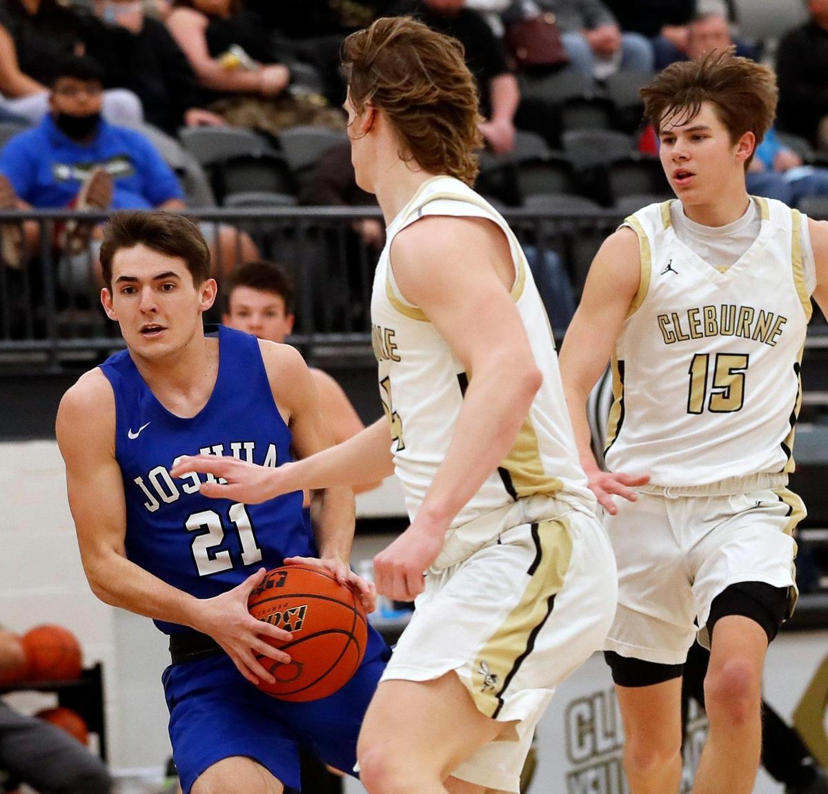 Joshua guard Logan Rice (21) runs into the defense of Cleburne’s Carson Harris (14) during the first half of a 14-5A high school basketball game at Cleburne High School in Cleburne, Texas, Tuesday, Feb. 09, 2021. Joshua led 43-28 at the half. (Special to the Star-Telegram Bob Booth)