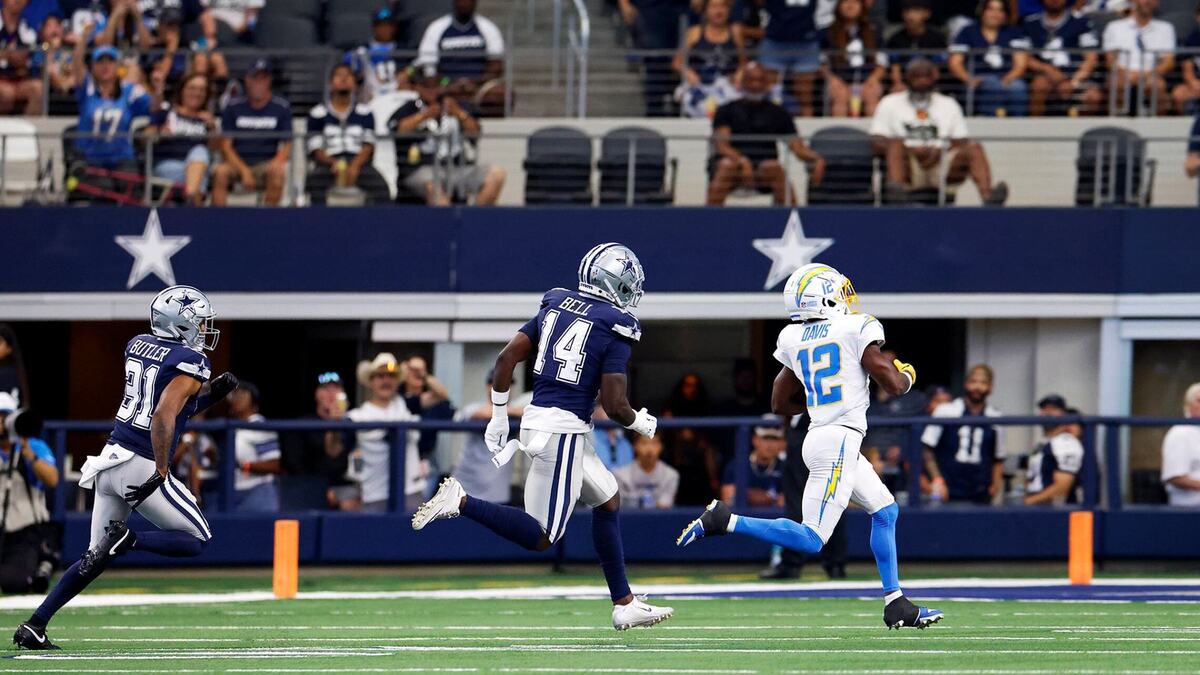 Dallas Cowboys cornerback Josh Butler (31) and safety Markquese Bell (14) attempt to chase down Chargers wide receiver Derius Davis during the first quarter on Saturday at AT&T Stadium in Arlington. Davis ran the ball for a touchdown.