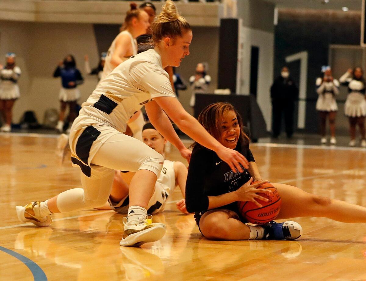 Keller guard Cambridge Mathews (2) and North Crowley guard Kayla Thompson (5) battle for the ball during the first half of a Division 6A Region 1 quarterfinal basketball game at Arlington ISD Complex in Arlington, Texas, Thursday, Feb. 25, 2021. Keller led 31-26 at the intermission. (Special to the Star-Telegram Bob Booth)