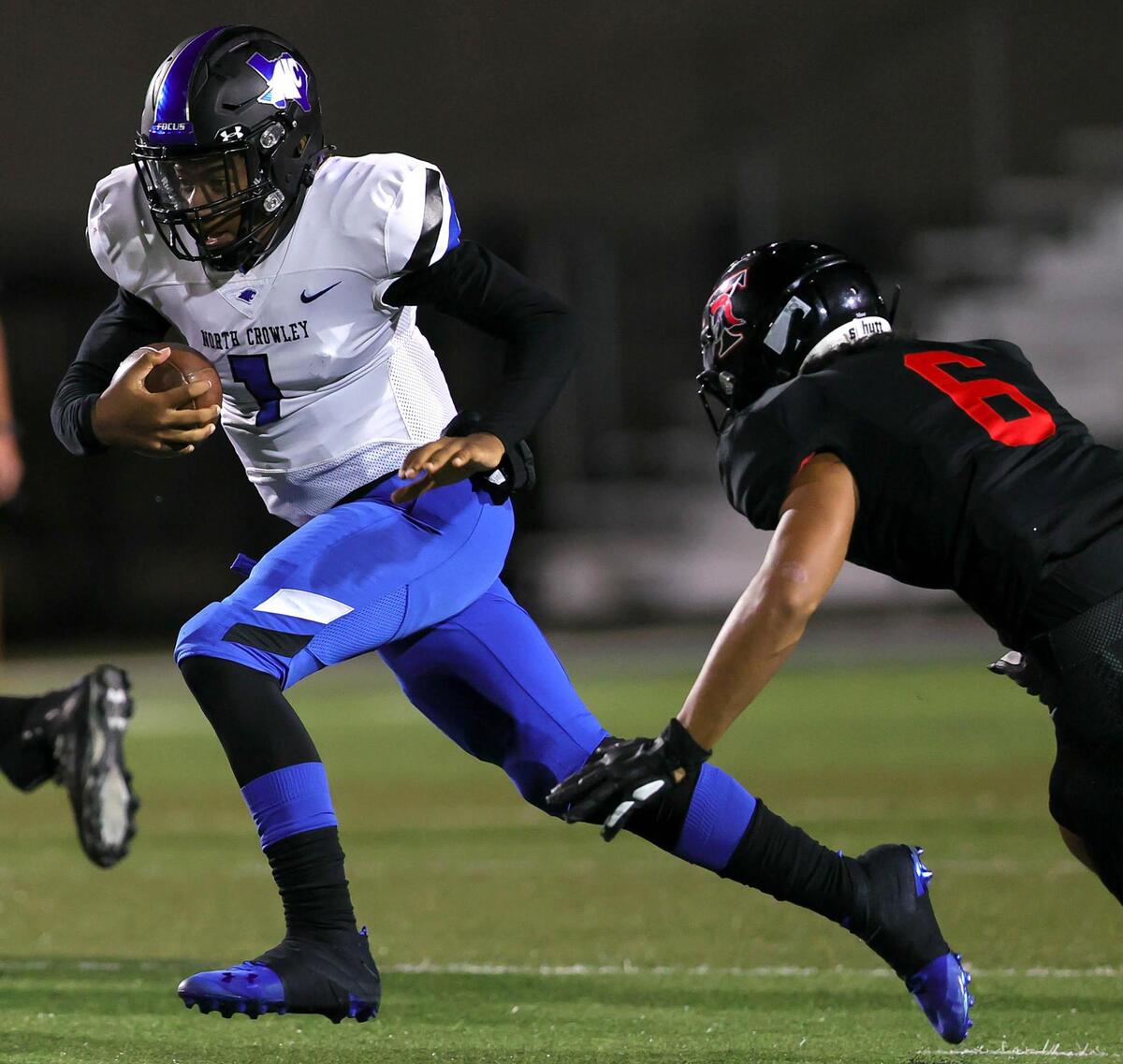North Crowley quarterback Chandler Pullam (1) tries to run past Trinity linebacker Nai Mose (6) during the first half of a high school football game, Thursday night, November 5, 2020 played at Pennington Field in Bedford, Tx. (Steve Nurenberg Special to the Star-Telegram)