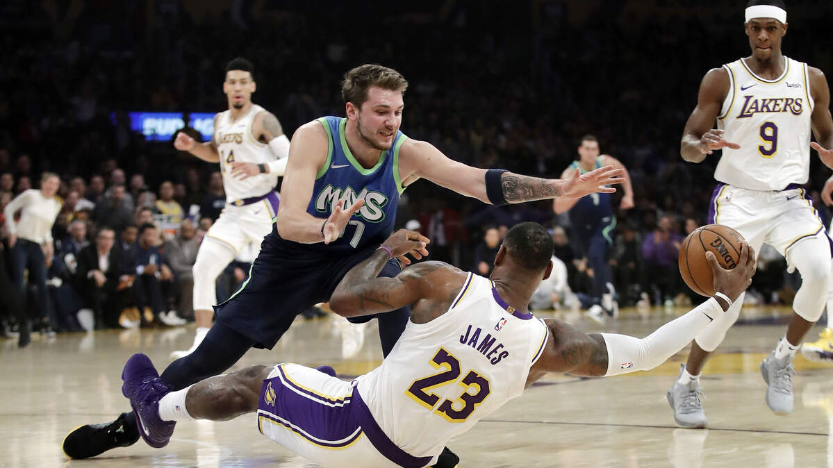 Dallas Mavericks guard Luka Donic, left, defends Los Angeles Lakers’ LeBron James during the first half of an NBA basketball game Sunday, Dec. 1, 2019, in Los Angeles, California.