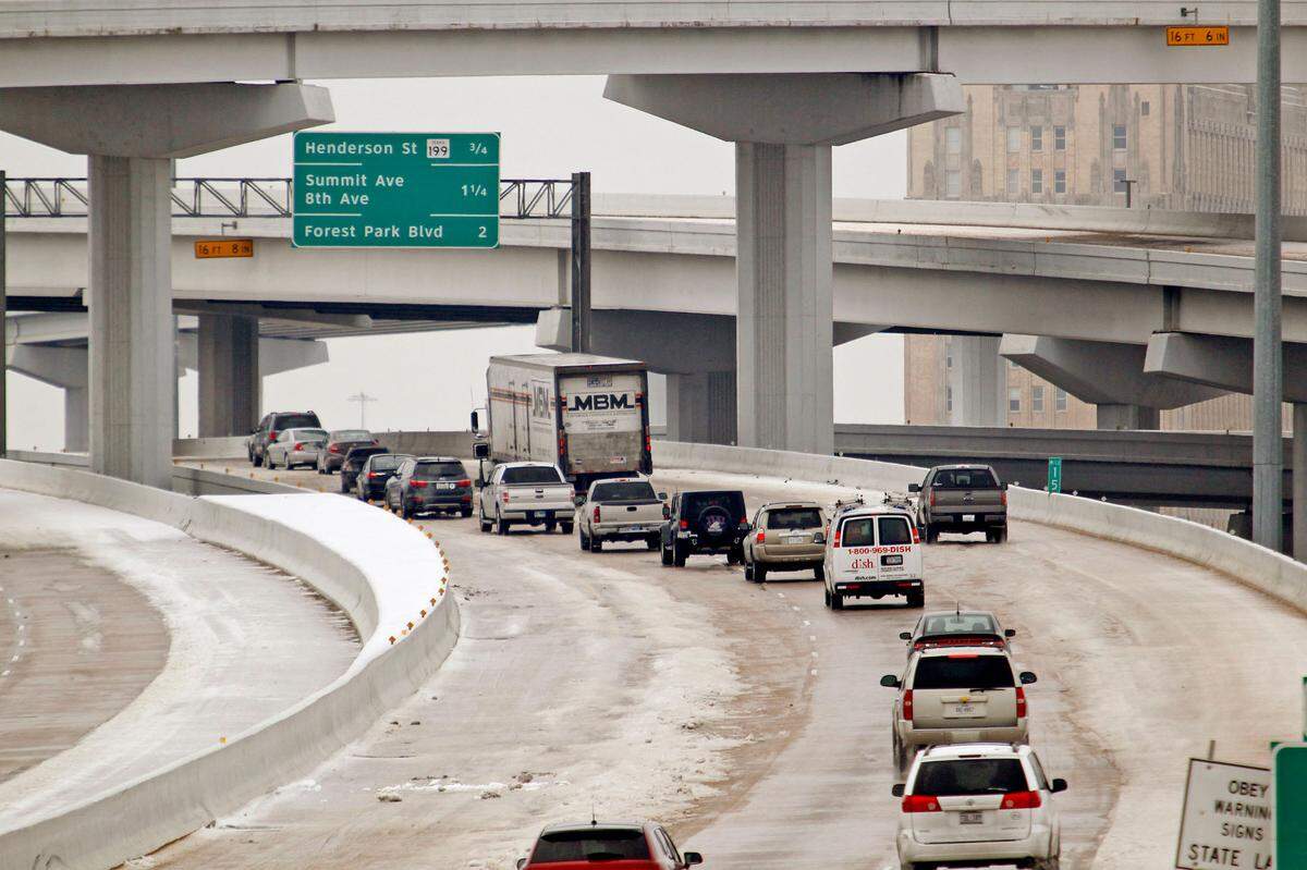 The I-35 W / I-30 mixmaster (looking west here) was slow but passable Sunday morning if drivers were careful. Cold and ice remained in Fort Worth Sunday, with roads especially treacherous in the the morning hours before temperatures rose, Sunday, December 8, 2013. (Star-Telegram/Paul Moseley)