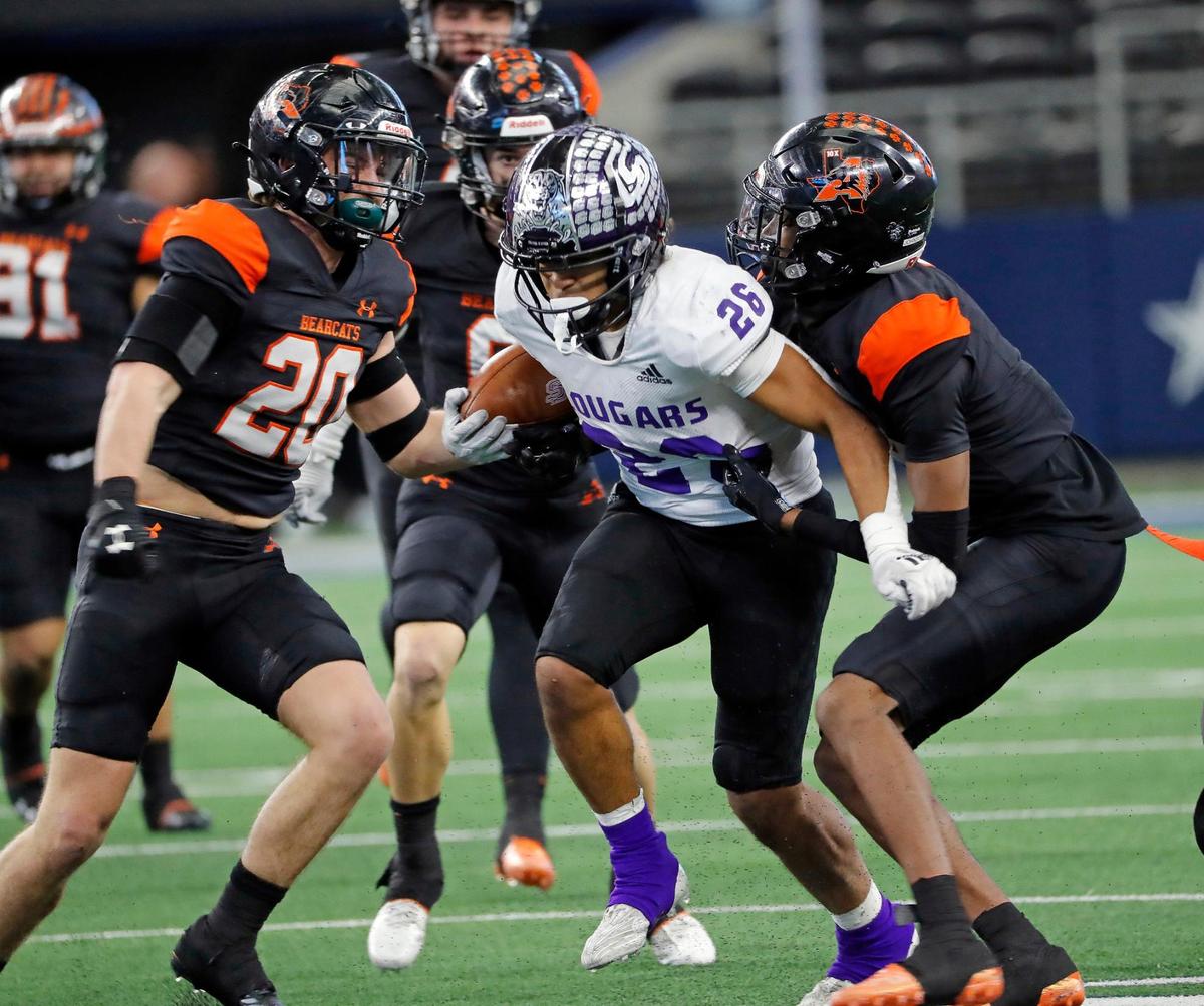 College Station running back Aydan Martinez-Brown (26) gets bottled up by the Aledo defense including linebacker Cap Mooney (20) in the second half of a UIL Class 5A D1 state championship football game at AT&T Stadium in Arlington, Texas, Saturday, Dec. 16, 2022. The Aledo Bearcats defeated The College Station Cougars 52-14. (Star-Telegram Bob Booth)