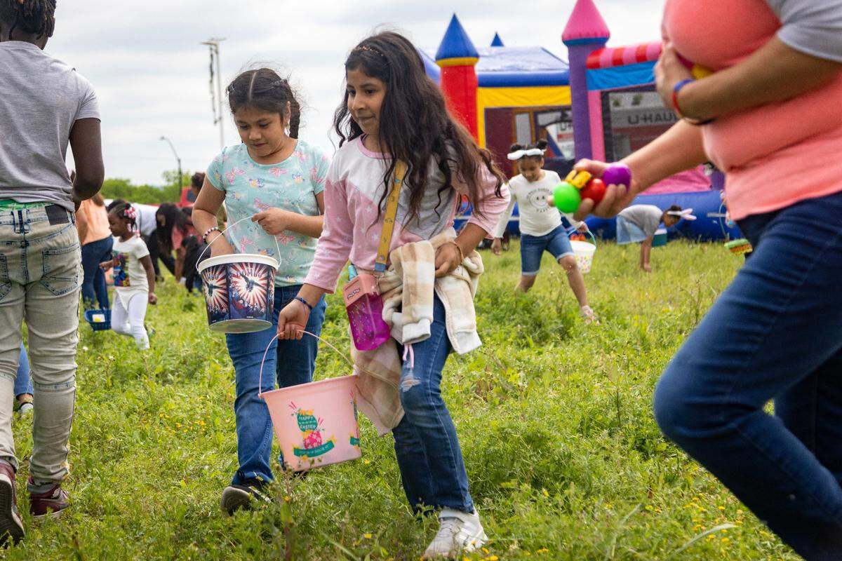 Perla Duarte, 8, (left) and Jade Duarte, 7, (right) search for eggs during the egg hunt at the Como Community Center in Fort Worth on Saturday, April 8, 2023.