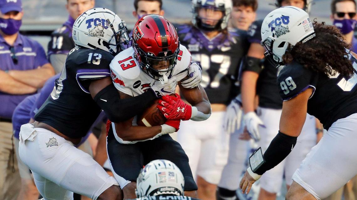 TCU linebacker Dee Winters (13) wraps up Texas Tech wide receiver Erik Ezukanma (13) during the first half of a NCAA college football game at Amon G. Carter Stadium in Fort Worth, Texas, Saturday, Nov. 07, 2020. TCU had a seven point lead at the half. (Special to the Star-Telegram Bob Booth)