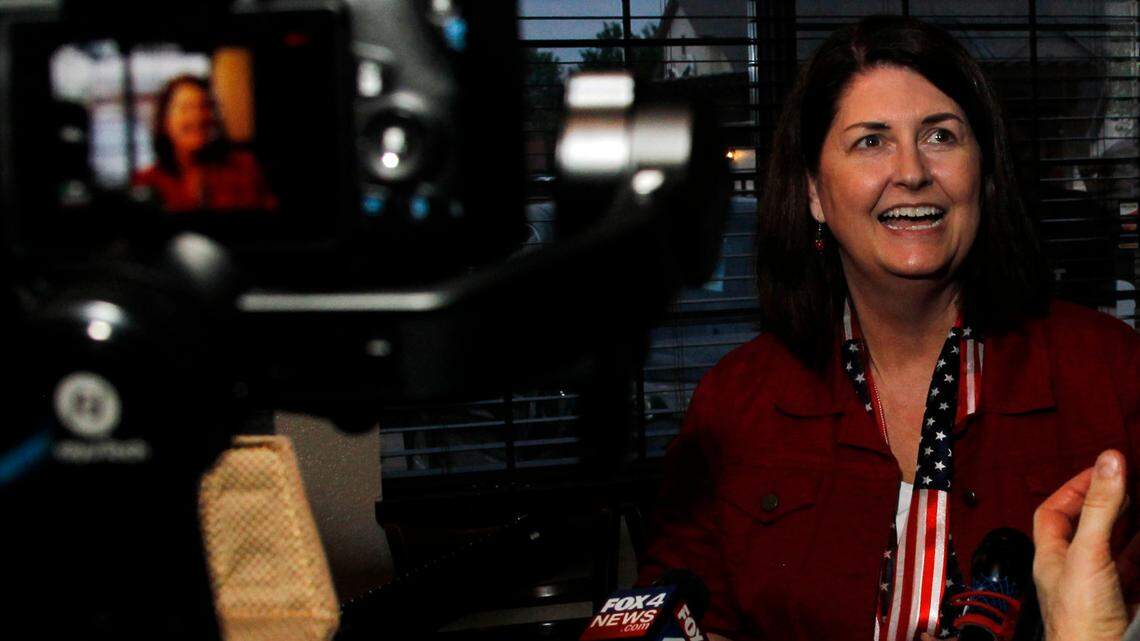 Susan Wright, candidate for Congress in District 6, converses with reporters during a brief news conference during her election party at El Primos in Mansfield.