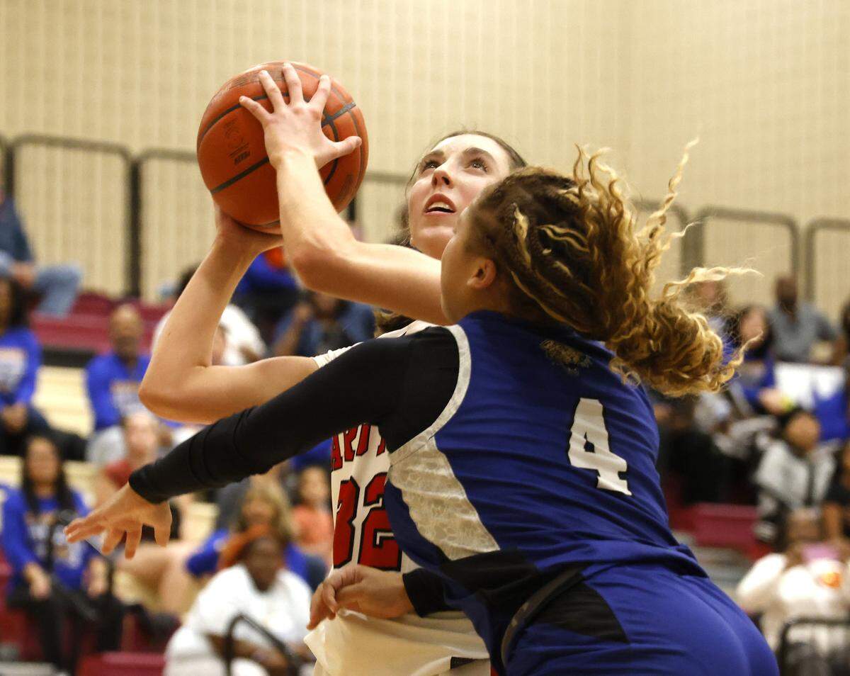Argyle guard Aoife Journagan (32) is fouled by Mansfield Summit guard I'yunna Warner (4) during the second half of a UIL Class 5A DII girls playoff basketball game at Saginaw High School in Saginaw, Texas, Thursday Feb. 19, 2026.