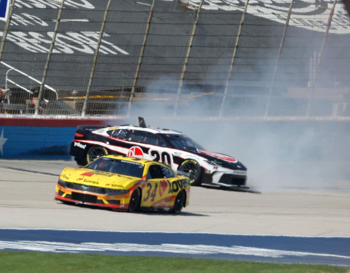 Christopher Bell (20) smacks the wall coming out of our four behind Michael McDowell (34) during the Auto Trader Echo Park 400 at Texas Motor Speedway in Fort Worth, Texas, April 14, 2024. Kyle Larson won stage 1. (Special to the Star-Telegram/Bob Booth)
