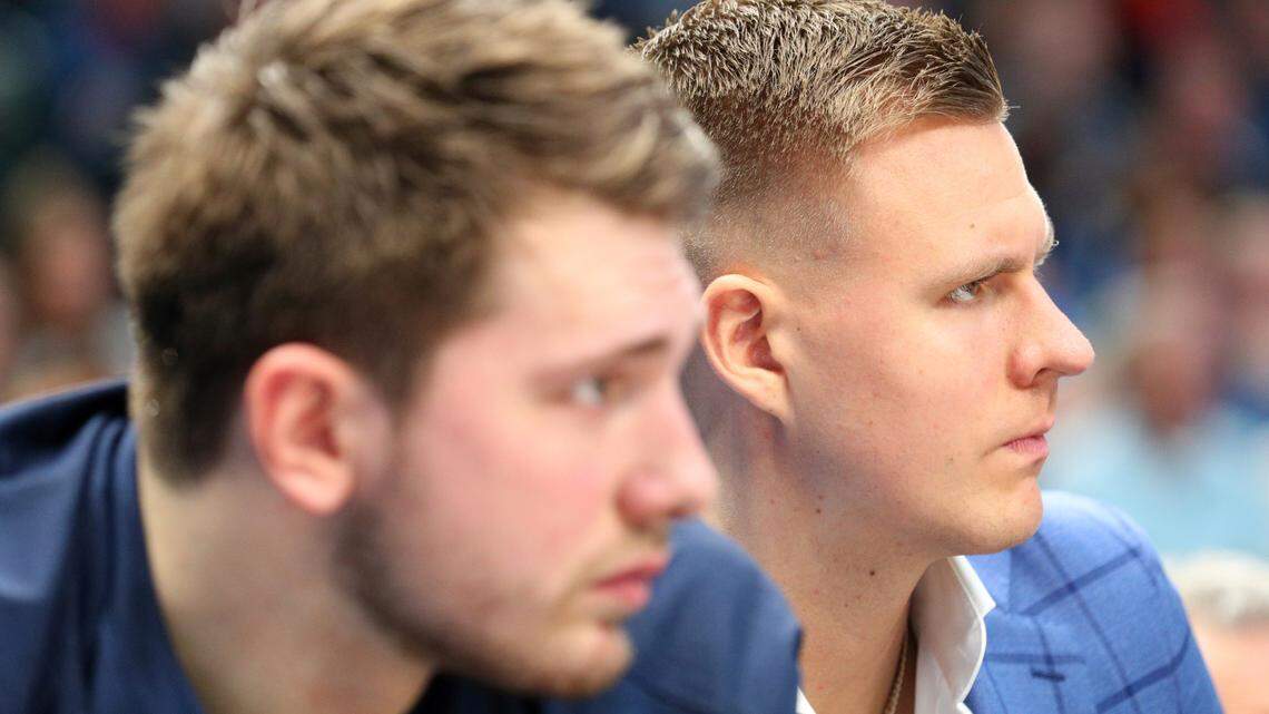 Dallas Mavericks forward Luka Doncic, left, and forward Kristaps Porzingis sit on the bench during the first half of the team’s NBA basketball game against the Los Angeles Lakers on Friday, Jan. 10, 2020, in Dallas. (AP Photo/Richard W. Rodriguez)