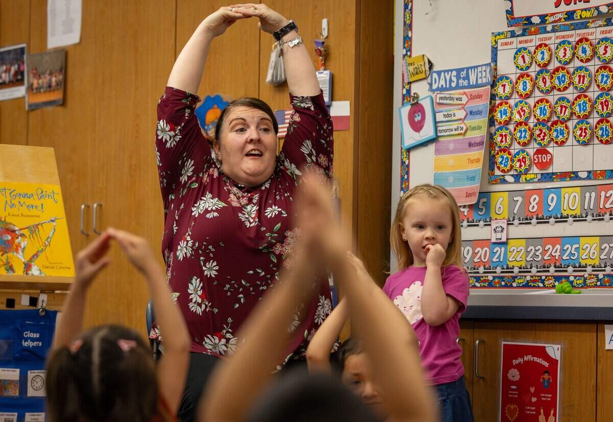 Teacher Sarah Waits practices a breathing exercise with her class during a pre-K prep program at Castleberry Elementary School in Fort Worth on June 29, 2026. The exercise helps students calm down and relax before beginning class.