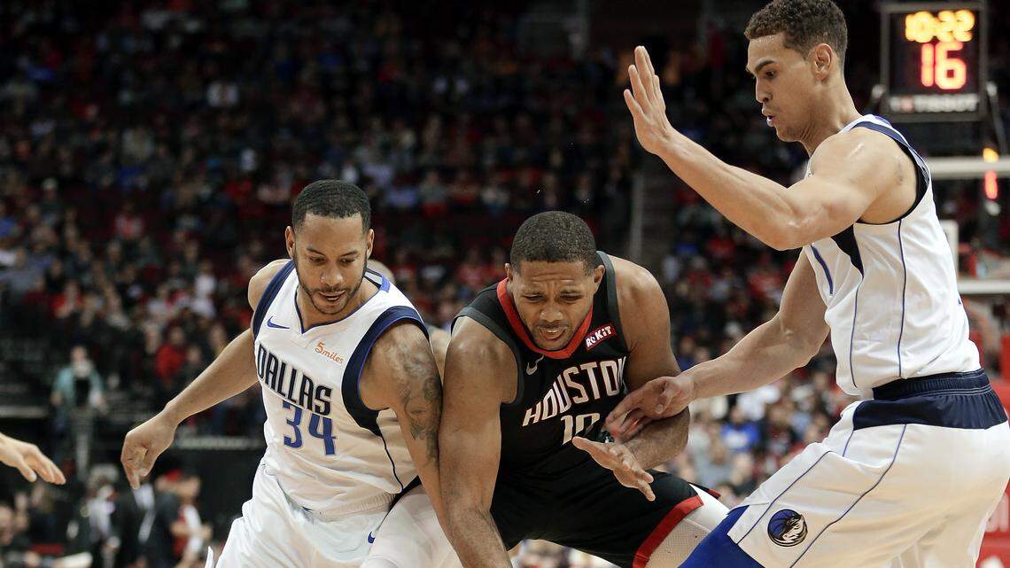 Devin Harris, left, and Dwight Powell swarmed Eric Gordon and the Rockets on Wednesday night in a 128-108 Mavs victory.